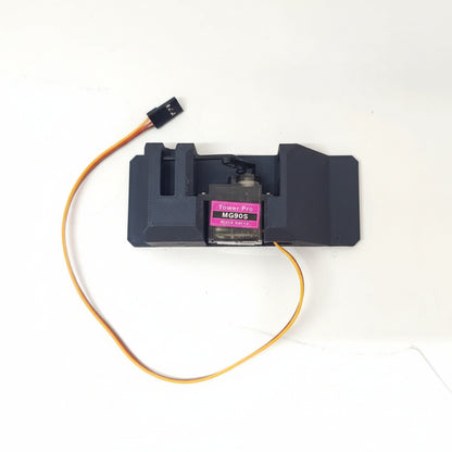 A black servo dispenser air drop rack kit with an attached orange wire and a MG90 servo motor.