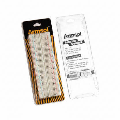 Armsol solarless breadboards in retail packaging on a plain white background. One package shows the breadboards through a clear front with a black and orange header card, and the other shows the back of the clear plastic packaging with printed specifications.