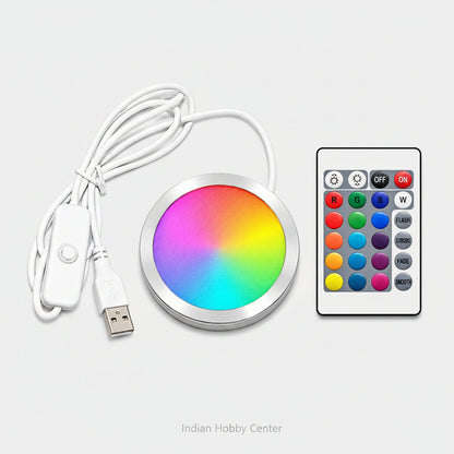 A round RGB LED light strip controller with a white USB cable and a white remote control, displayed on a clean white background.