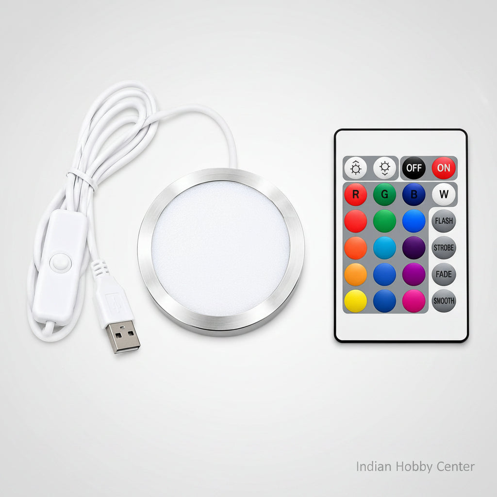 A round LED light strip kit with a white USB cable, white inline switch, and a white remote control featuring colorful buttons for red, green, blue, white, flash, strobe, fade, and smooth.
