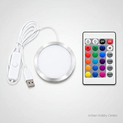 A round LED light strip kit with a white USB cable, white inline switch, and a white remote control featuring colorful buttons for red, green, blue, white, flash, strobe, fade, and smooth.