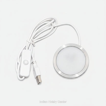 A white USB-controlled LED under-shelf light with a circular silver metal frame, white cable, and inline switch on a white background.