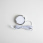 A round recessed LED light fixture with a brushed silver metal rim and a white diffuser, shown with its coiled white power cable on a plain white background.