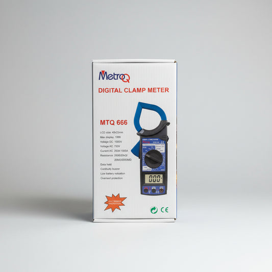 Metro Q digital clamp meter packaging on a table with a blurred background