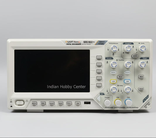 Digital oscilloscope on a table with technical literature in the background