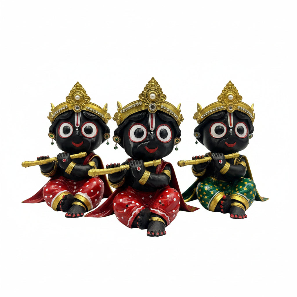 Three black and gold神像 figurines with red and gold attire on a blue surface.