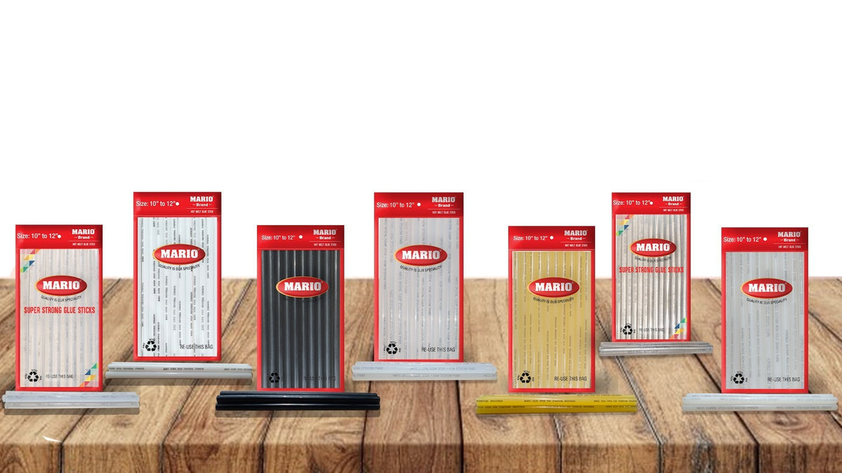 A product display of various Mario Industries hot melt glue sticks in different colors, including Jelly, Milky, Black, Crystal, Yellow, Mini Crystal, and Diamond, arranged on a wooden surface with a white background and brand logos.