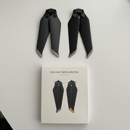 Two black propellers with gray tips displayed above their white retail box labeled 'LOW-NOISE PROPELLERS(PAIR) FISHAWL C'.
